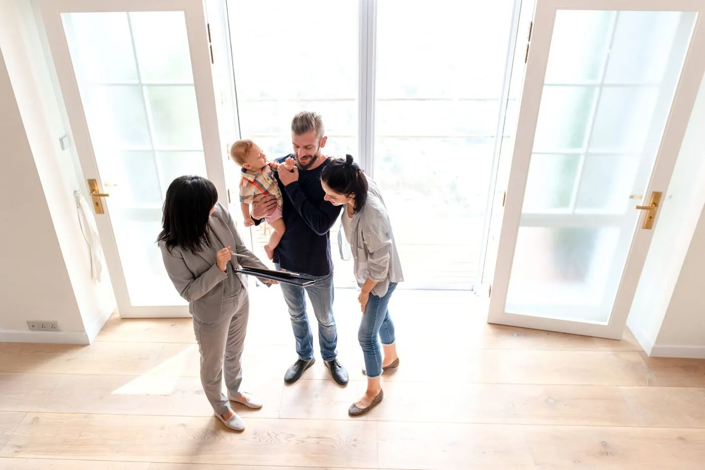 An agent showing a young family through a bright home