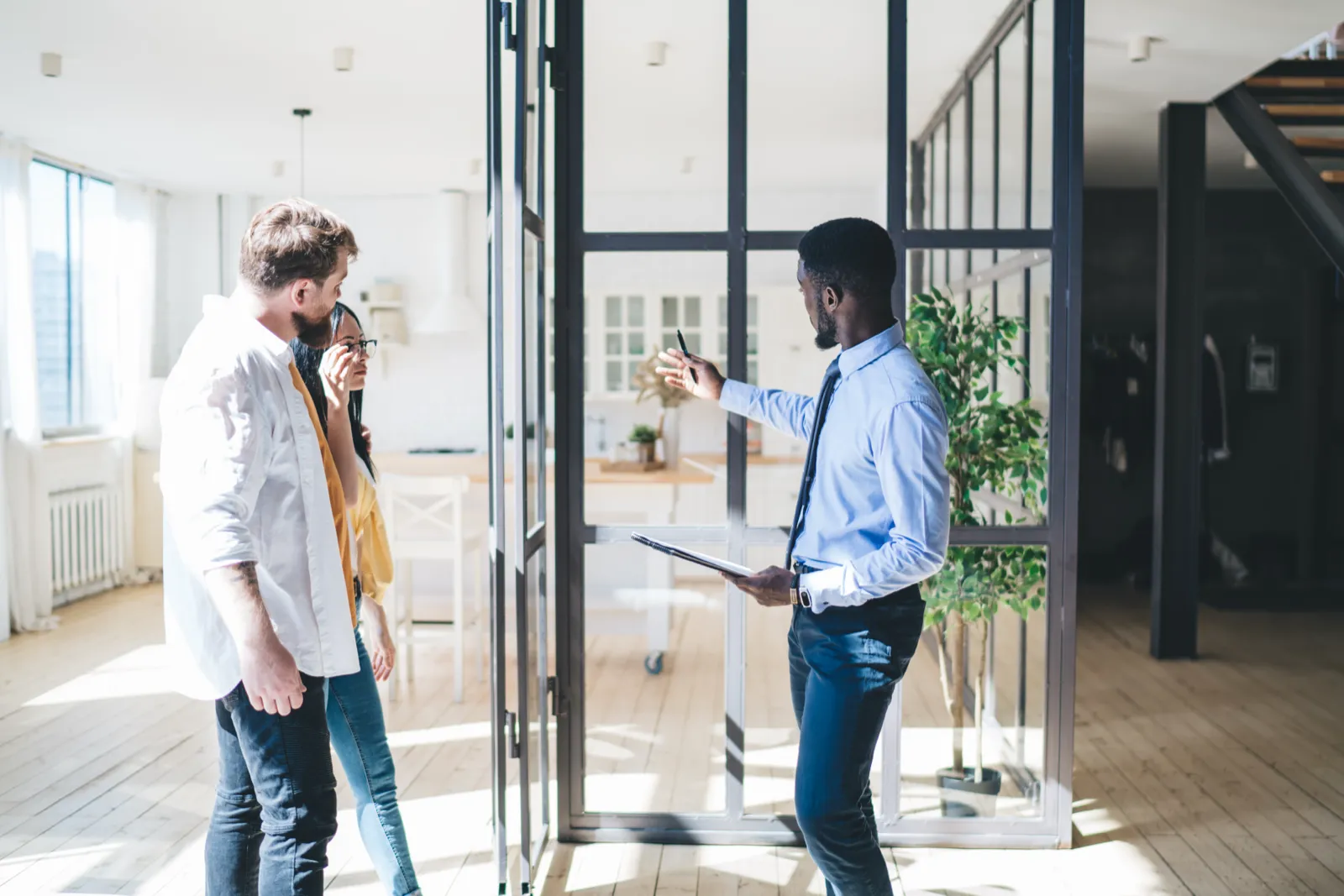 An agent showing a home to a couple