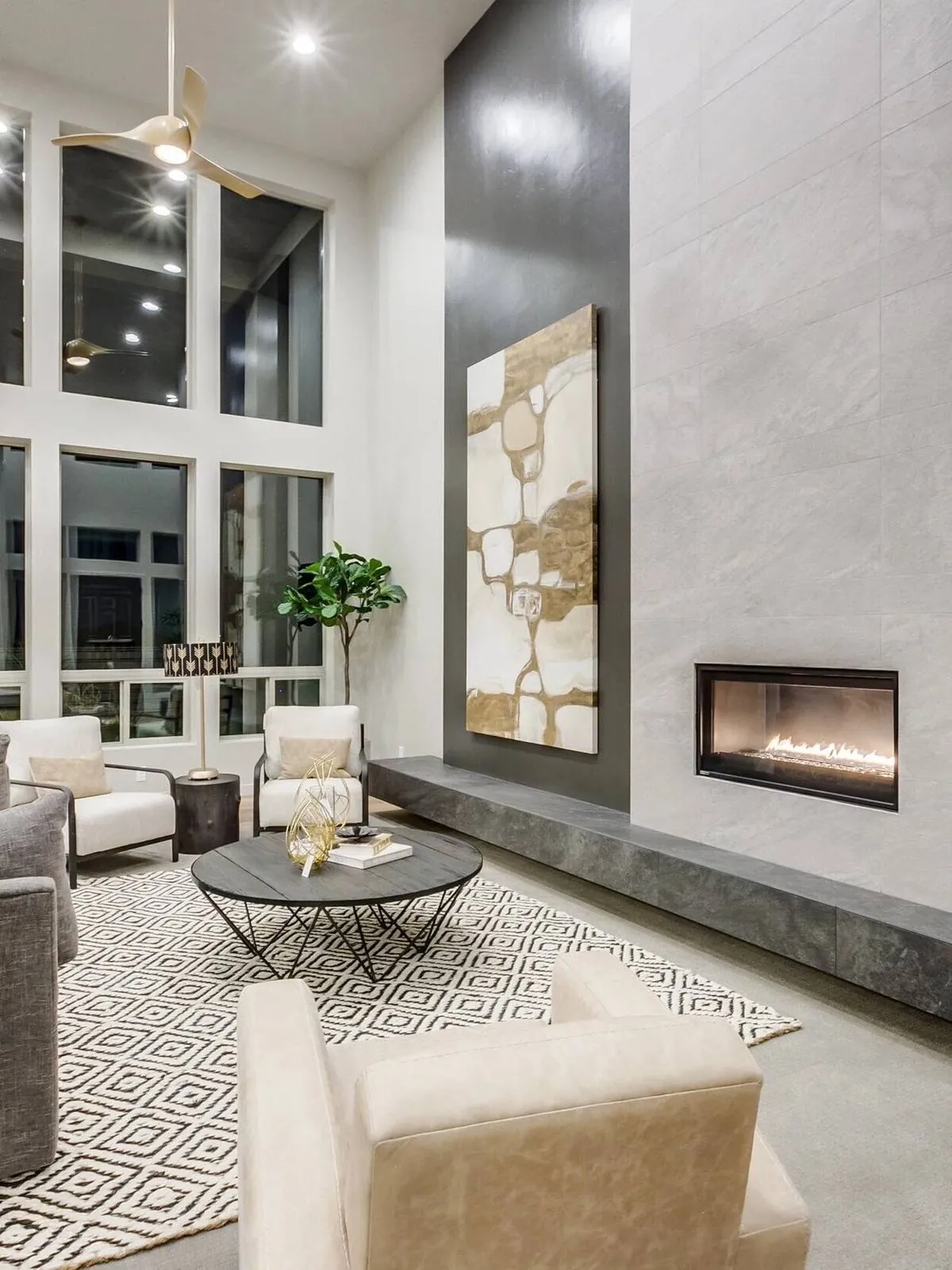 Luxury great room with a linear fireplace and two-story windows