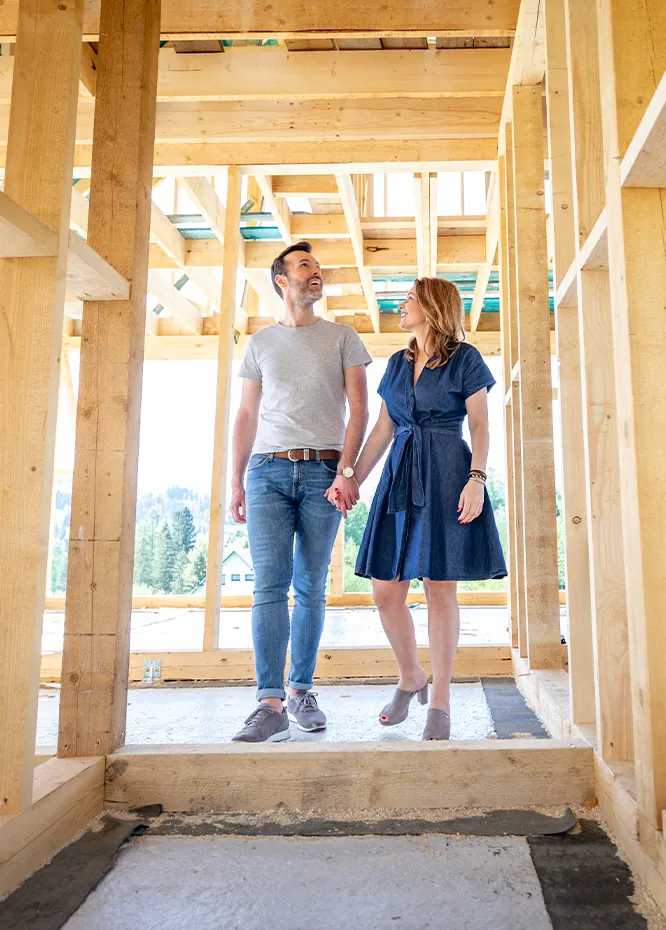 A couple reviewing plans at their new home under construction