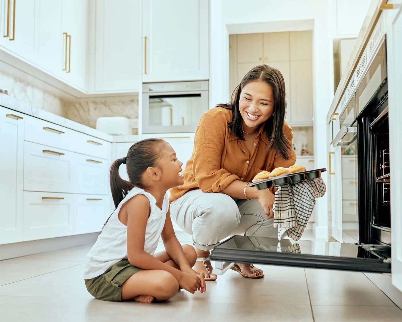 A mother and daughter baking together in a bright kitchen