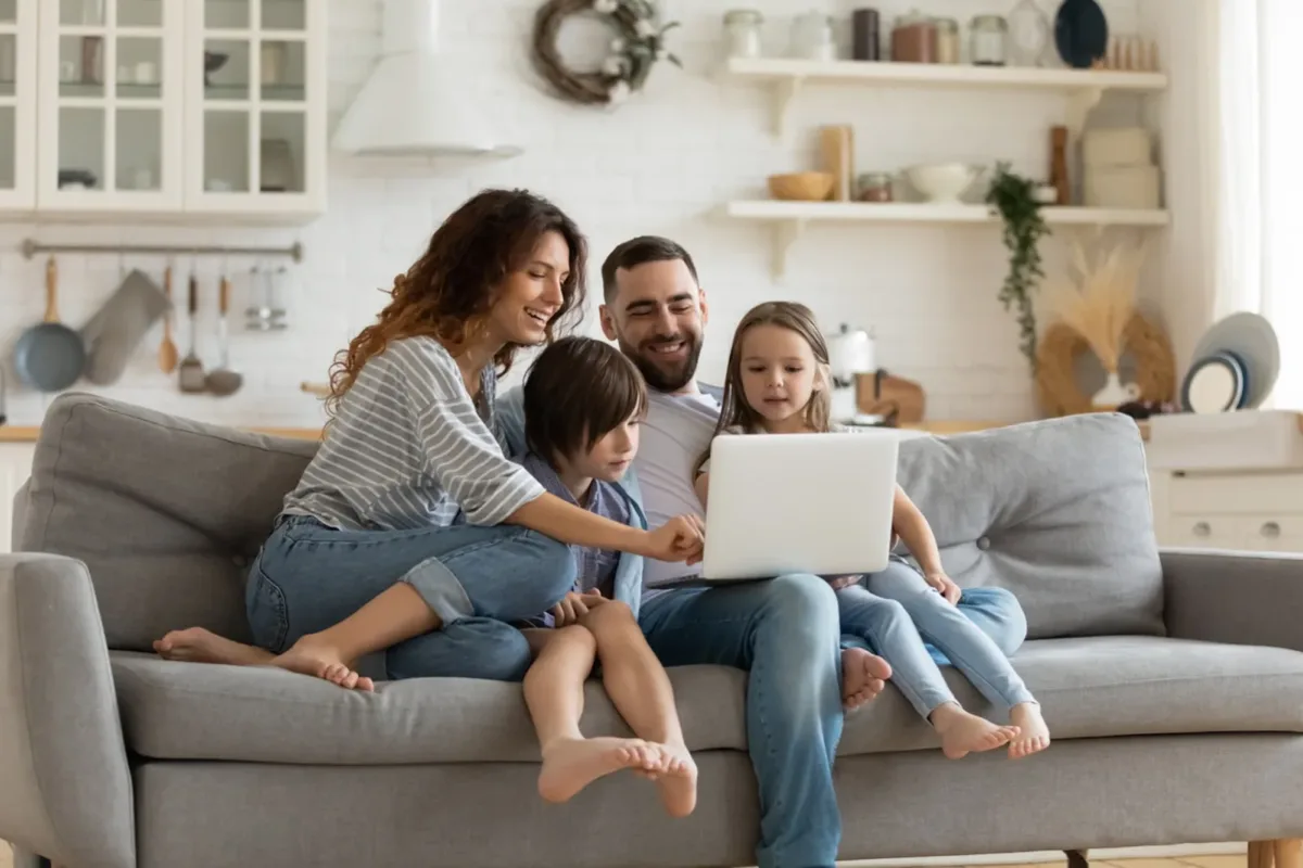 A family looking at homes together on a laptop