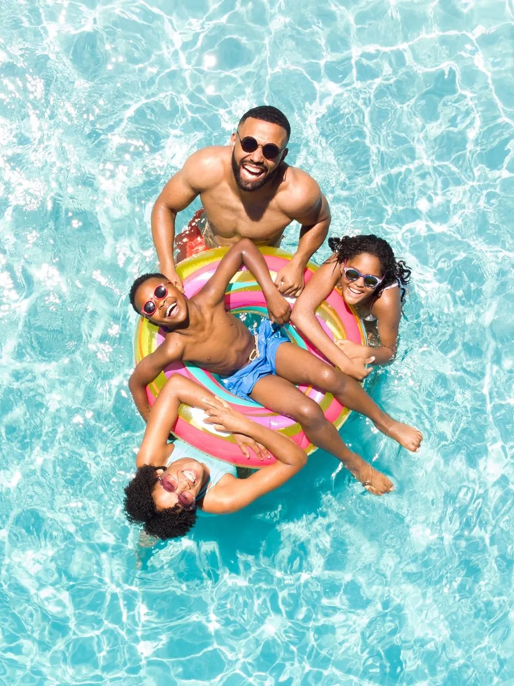 A family floating in a community swimming pool