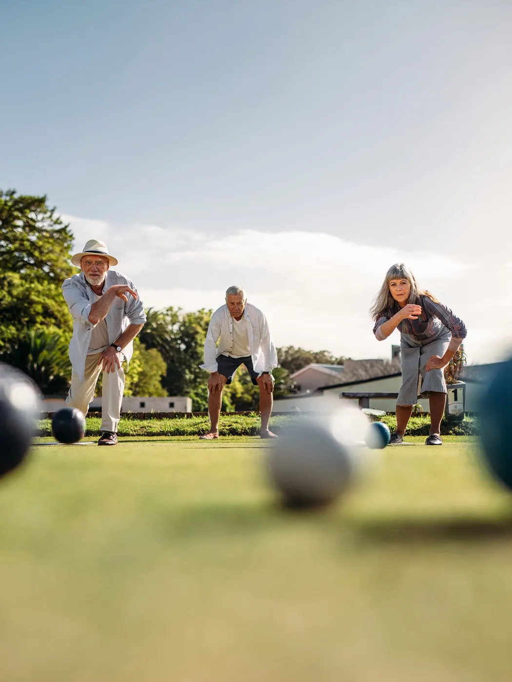 Neighbors playing bocce ball in a community park