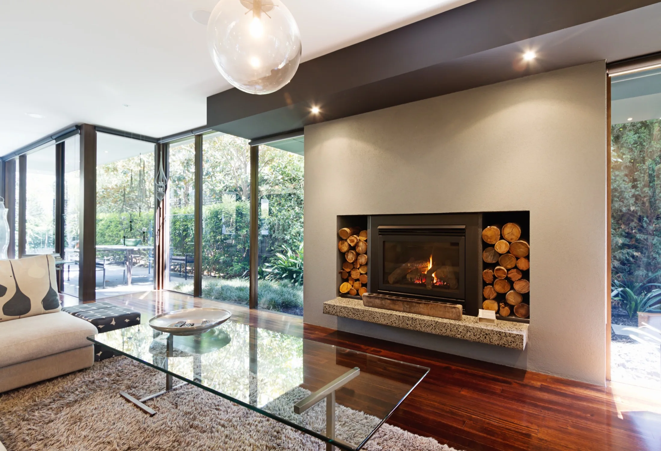 Modern living room with a fireplace and floor-to-ceiling windows